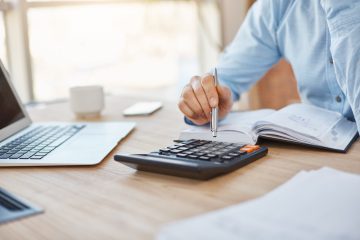 close-up-detail-professional-serious-accountant-sitting-light-office-checking-company-finance-profits-calculator